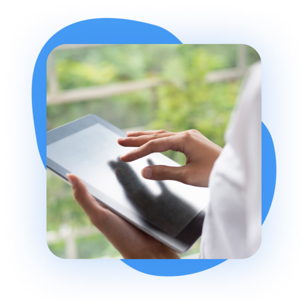 Person using a tablet, hands tapping on the screen, soft background with blurred greenery, enclosed in a blue frame.